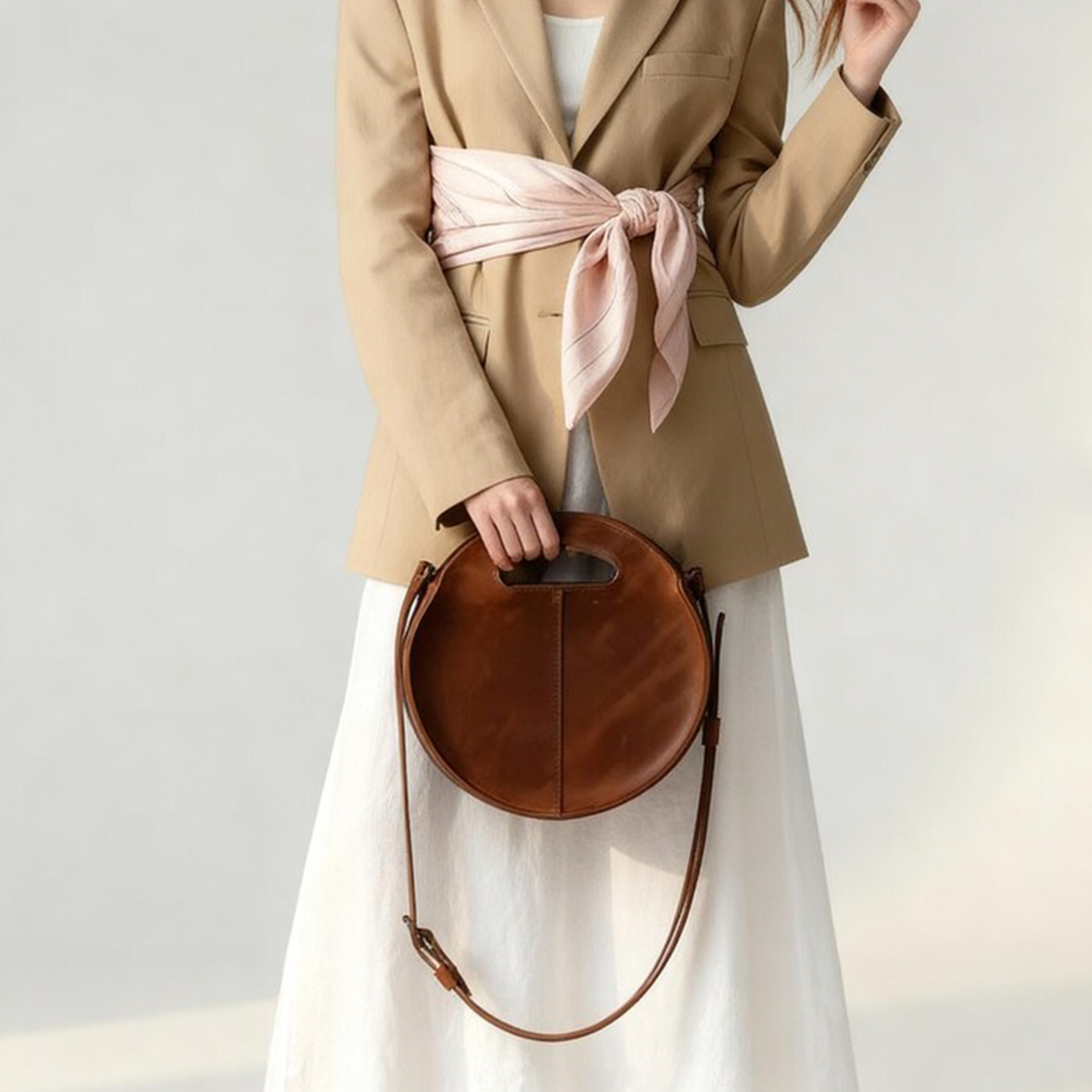 Warm Caramel Circular Hollow Handle Shoulder Bag With Central Vertical Stitch Seam And Side Mounted Long Hanging Fixture