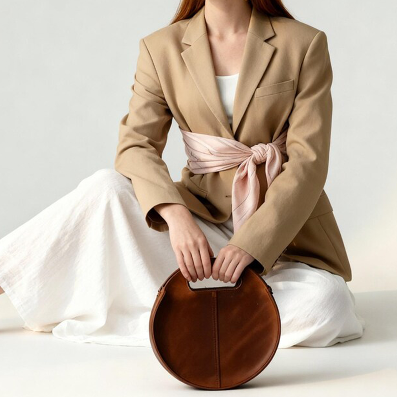 Warm Caramel Circular Hollow Handle Shoulder Bag With Central Vertical Stitch Seam And Side Mounted Long Hanging Fixture