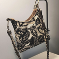 Monochrome Leaf Print Slouchy Shoulder Carryall With Bronze Metal Ring Hardware And Brown Lined Interior Slip Slot