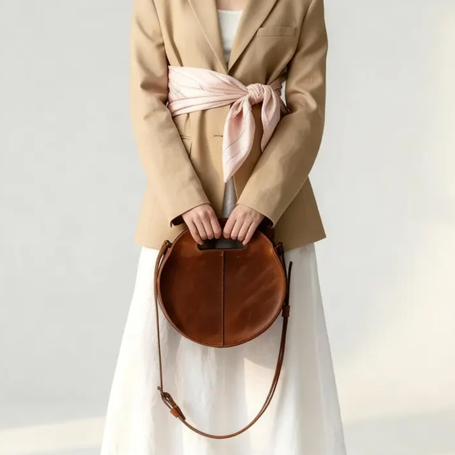 Warm Caramel Circular Hollow Handle Shoulder Bag With Central Vertical Stitch Seam And Side Mounted Long Hanging Fixture